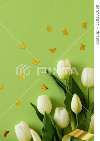 White Tulips and Butterflies Confetti with Ribbon on Green Spring Background White Tulips and Butterflies Confetti with Ribbon on Green Spring Background 138161060