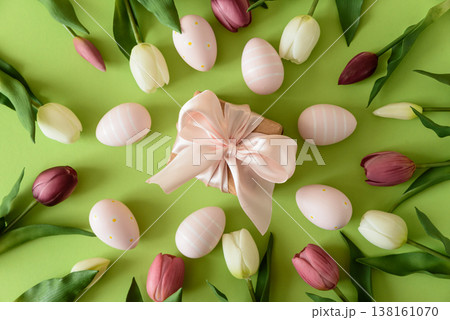 Easter Gift Box with Eggs and Spring Tulips on Green Background 138161070