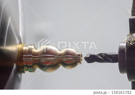 Precision hole drilling process on a brass material shaft using a professional CNC turning machine. 138161782