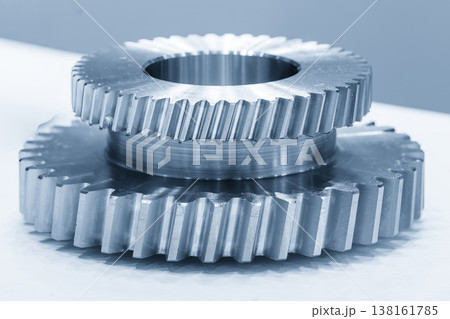 Close-up of high-precision metal double end bevel gear parts for industrial transmission and powertrain systems. Close-up of high-precision metal double end bevel gear parts for industrial transmission and powertrain systems. 138161785