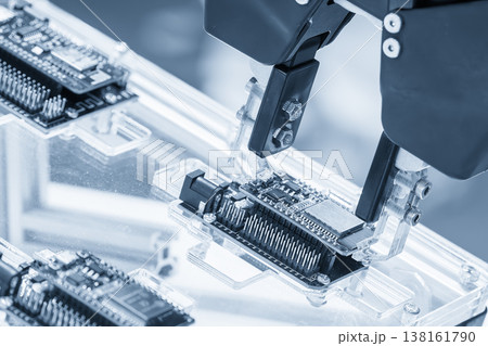 Advanced automatic robotic system moving assembled circuit boards (PCB) on a high-tech production line in a smart factory. Advanced automatic robotic system moving assembled circuit boards (PCB) on a high-tech production line in a smart factory. 138161790