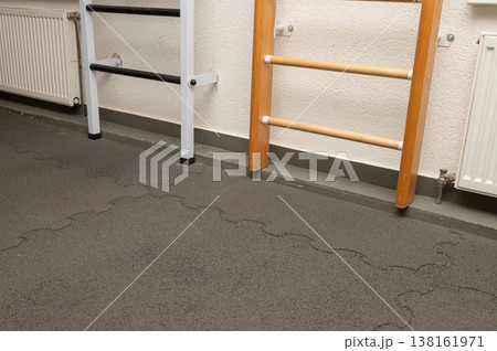 Gym wall bars with protective flooring in exercise room 138161971