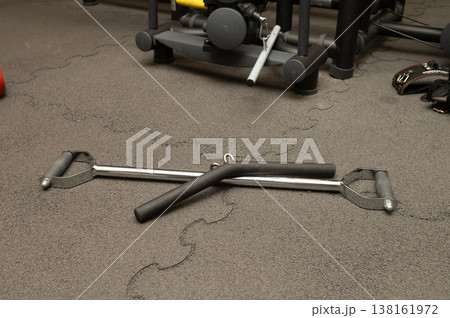 Gym equipment on floor: two handles with bar for effective strength training 138161972