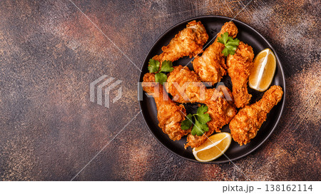 Fried chicken legs with lemon and parsley. Fried chicken legs with lemon and parsley. 138162114