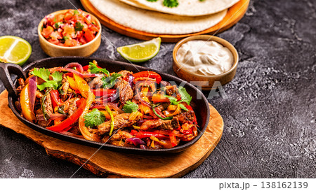 FAJITAS with colored pepper and onions, served with tortillas. 138162139