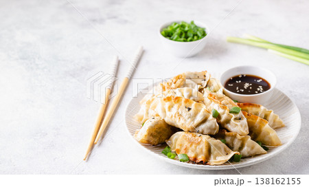 Fried dumplings gyoza with soy sauce, and chopsticks. Fried dumplings gyoza with soy sauce, and chopsticks. 138162155