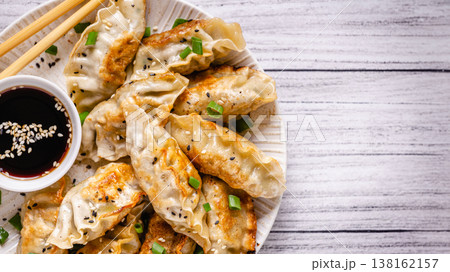 Fried dumplings gyoza with soy sauce, and chopsticks. Fried dumplings gyoza with soy sauce, and chopsticks. 138162157