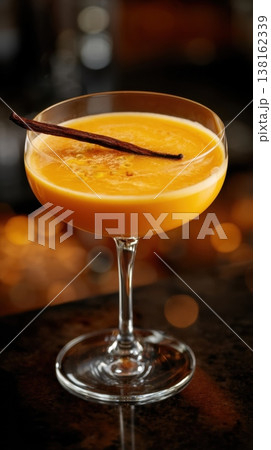Elegant coupe filled with orange cocktail and vanilla pod Elegant coupe filled with orange cocktail and vanilla pod 138162339