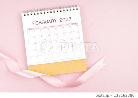 February 2027 desk calendar with pink pastel ribbon. February 2027 desk calendar with pink pastel ribbon. 138162380