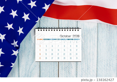 October 2026 monthly desk calendar with United States of America flag on wooden. October 2026 monthly desk calendar with United States of America flag on wooden. 138162427
