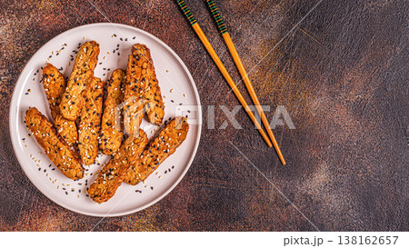 Fried tempeh  with sesame seeds. 138162657