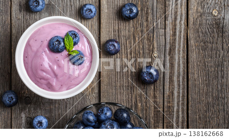 Homemade yogurt with fresh blueberry on a wooden background. Homemade yogurt with fresh blueberry on a wooden background. 138162668