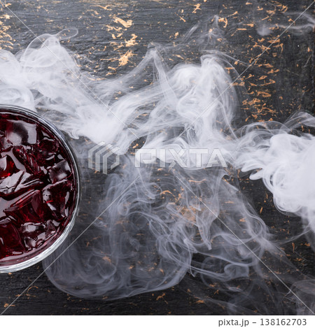 Red cocktail with ice and smoke 138162703