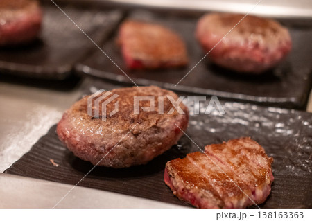 Grilled Hamburg, a patty of ground beef, with steak on the plate 138163363