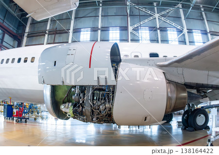 Close-up of an open high bypass turbofan airplane engine of a passenger aircraft in aviation hangar Close-up of an open high bypass turbofan airplane engine of a passenger aircraft in aviation hangar 138164422