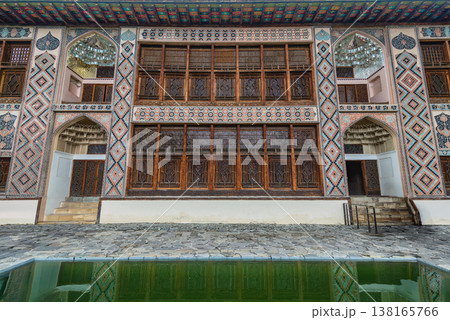 Detailed facade of Shaki Khan Palace with colorful mosaics and wooden windows reflected in pool, Shaki Azerbaijan 138165766