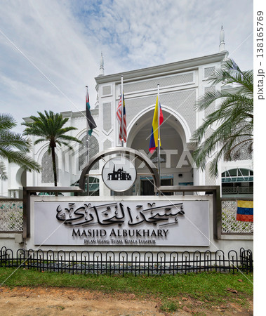 Al-Bukhari Mosque sign and entrance with flags and palm trees, Kuala Lumpur, Malaysia Al-Bukhari Mosque sign and entrance with flags and palm trees, Kuala Lumpur, Malaysia 138165769