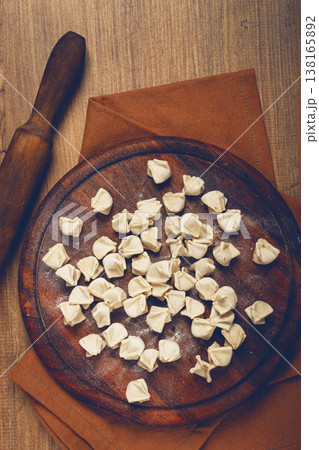Traditional Turkish dumplings,raw, on a cutting board, top view, no people, Traditional Turkish dumplings,raw, on a cutting board, top view, no people, 138165892