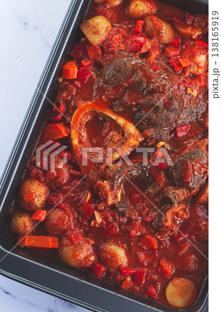 ossobuco stew with vegetables, knuckle on the bone with new potatoes, in tomato sauce,homemade, top view, no people, 138165919