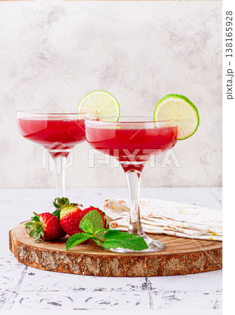 Refreshing cocktail in an elegant glass with lime and strawberries, sunshine, no people, 138165928