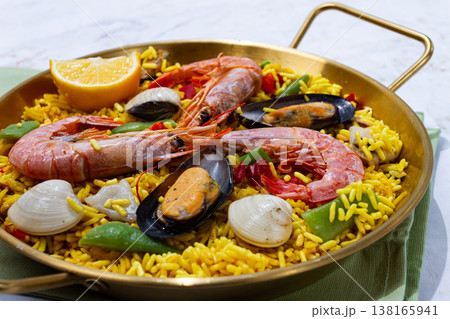 Seafood paella, shrimp and mussel risotto, rice, paella in a pan, homemade, natural light, top view, no people, 138165941