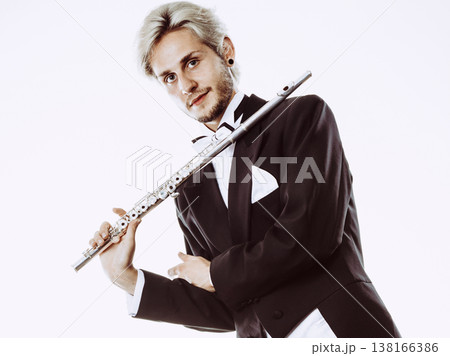 Male flutist wearing tailcoat holds flute Male flutist wearing tailcoat holds flute 138166386