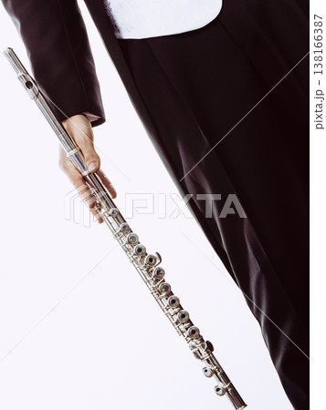 Male flutist wearing tailcoat holds flute 138166387