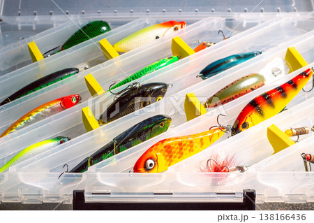 Transparent fishing tackle box containing lures hooks bobber. Image for fishing themes Transparent fishing tackle box containing lures hooks bobber. Image for fishing themes 138166436