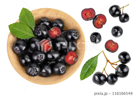 Chokeberry with leaf in a wooden bowl isolated on white background. Black aronia. Top view. Flat lay Chokeberry with leaf in a wooden bowl isolated on white background. Black aronia. Top view. Flat lay 138166549