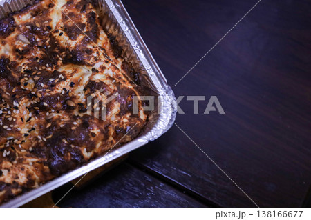 Traditional baked pie in a functional foil tray suitable for catering and food delivery services. Traditional baked pie in a functional foil tray suitable for catering and food delivery services. 138166677