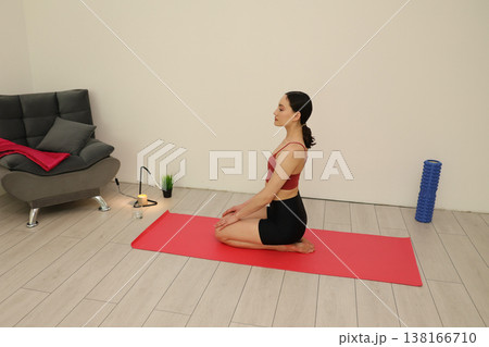 Yoga practice in a serene indoor space with gentle lighting and comfortable furniture enhancing mindfulness Yoga practice in a serene indoor space with gentle lighting and comfortable furniture enhancing mindfulness 138166710