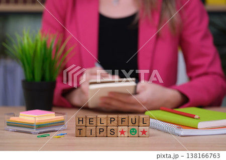 Engaging in creativity and learning with helpful tips on a wooden table filled with colorful stationery Engaging in creativity and learning with helpful tips on a wooden table filled with colorful stationery 138166763