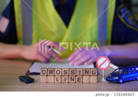 Traffic officer reviews rules at a safety checkpoint with toys and signs highlighting safety concerns in the community Traffic officer reviews rules at a safety checkpoint with toys and signs highlighting safety concerns in the community 138166803