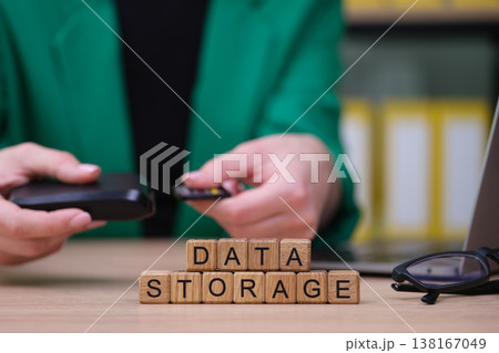 Exploring modern data storage solutions with an external drive and wooden blocks illustrating vital tech concepts 138167049