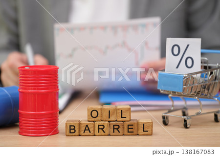 Business meeting explores market trends and oil prices as visualized by barrels and charts in a professional setting Business meeting explores market trends and oil prices as visualized by barrels and charts in a professional setting 138167083