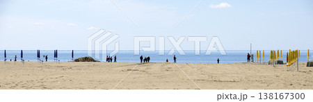 Walkers at the brink of the adriatic sea 138167300