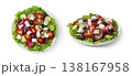 Greek salad in a flat plate close-up view from above and from the side isolated on a white background. 138167958