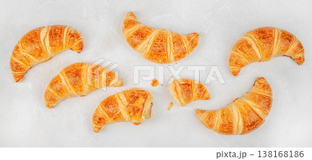 Croissants collection with bitten croissant on white background, top view bakery assortment Croissants collection with bitten croissant on white background, top view bakery assortment 138168186