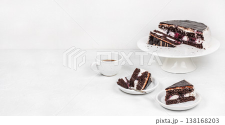 Chocolate cake and slices with coffee on white background and copy space Chocolate cake and slices with coffee on white background and copy space 138168203
