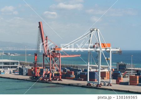 Container terminal with cranes and stacked shipping containers. Barcelona, Spain Container terminal with cranes and stacked shipping containers. Barcelona, Spain 138169365