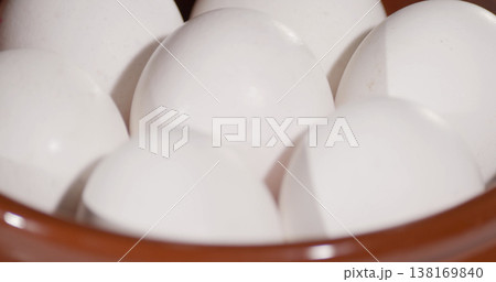 Bowl holds white eggs ready for cooking or baking at home kitchen in the daytime Bowl holds white eggs ready for cooking or baking at home kitchen in the daytime 138169840