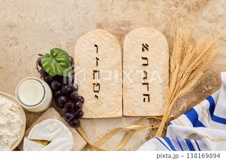 Shavuot holiday showing torah tablets and common food items Shavuot holiday showing torah tablets and common food items 138169894