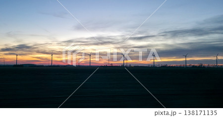 Wind turbines against the backdrop of a colorful picturesque sunset. Alternative eco-friendly sources of electricity. High quality photo Wind turbines against the backdrop of a colorful picturesque sunset. Alternative eco-friendly sources of electricity. High quality photo 138171135