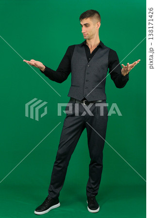 emotions of handsome man guy on a green background chromakey close-up dark hair young man 138171426