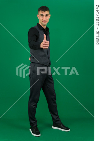 emotions of handsome man guy on a green background chromakey close-up dark hair young man 138171442