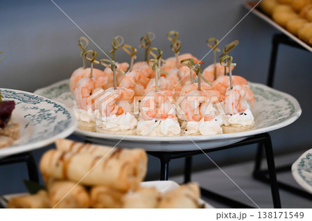 Assorted catering appetizer with shrimp canape and cream cheese on skewer for event or party decoration with delicious seafood snack on buffet table Assorted catering appetizer with shrimp canape and cream cheese on skewer for event or party decoration with delicious seafood snack on buffet table 138171549