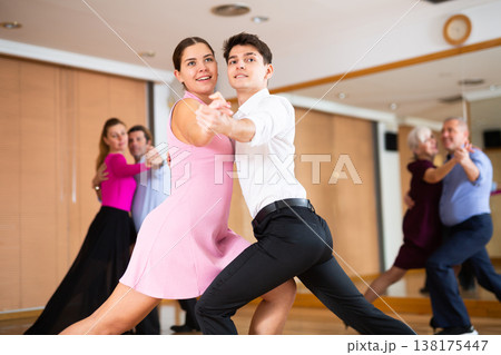 Young pair practicing ballroom dance in dance studio Young pair practicing ballroom dance in dance studio 138175447