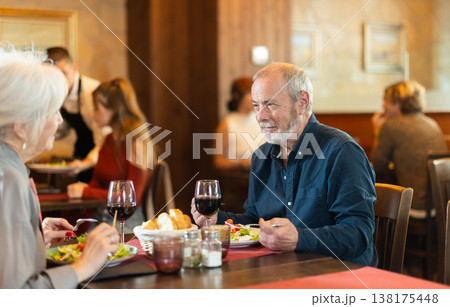 Happy senior couple enjoying dinner together in restaurant Happy senior couple enjoying dinner together in restaurant 138175448
