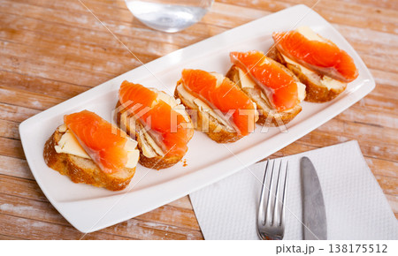 Delicious sandwiches with salmon and butter on white plate Delicious sandwiches with salmon and butter on white plate 138175512