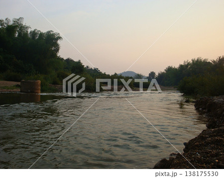 River water nature landscape outdoor sunset sky tree forest mountain peaceful river water flowing through green nature landscape soft sunset sky with tree forest and distant mountain creating calm River water nature landscape outdoor sunset sky tree forest mountain peaceful river water flowing through green nature landscape soft sunset sky with tree forest and distant mountain creating calm 138175530
